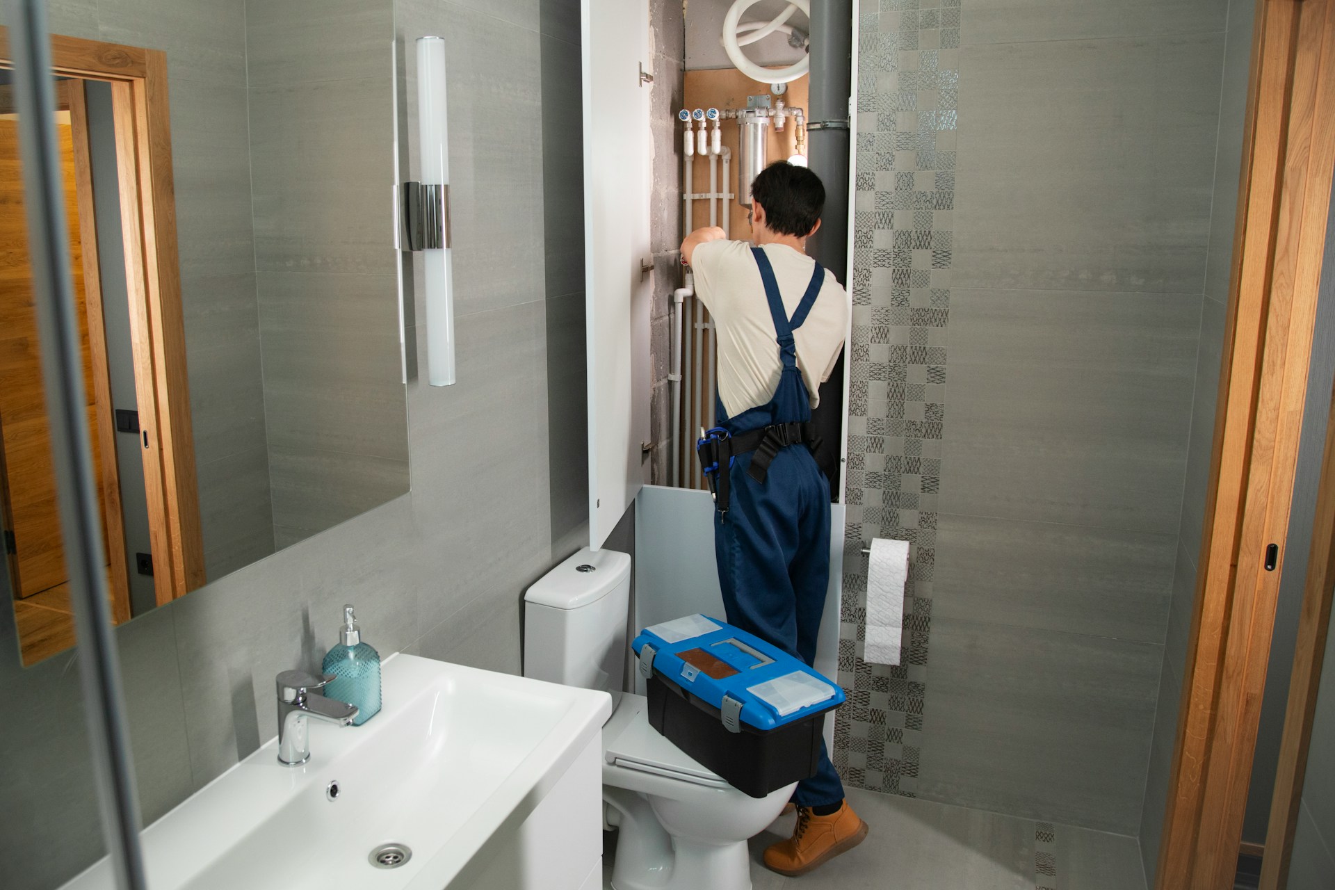 Plumber installing bathroom pipework